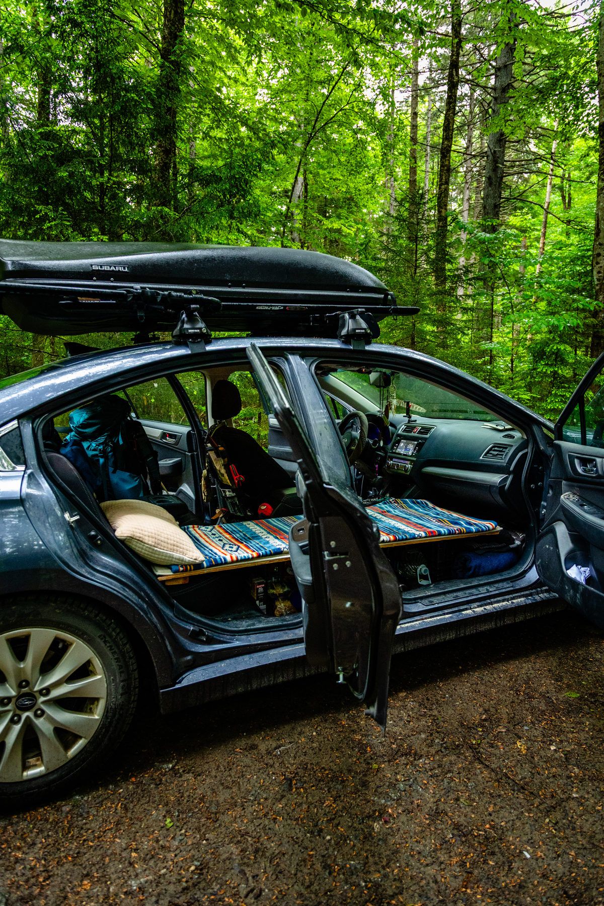 Tom Tranfaglia's Subaru set up for car camping in the woods, doors open